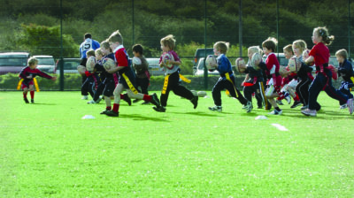 Kids playing at high-quality synthetic grass for outdoor and indoor flooring